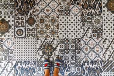 Upper view of summer shoes and decorative retro porcelain tile